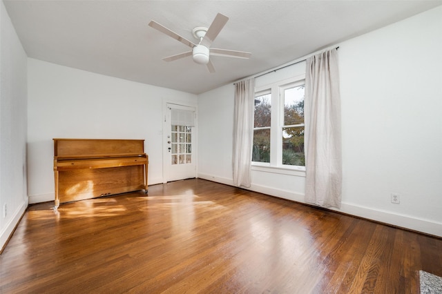 2615 W Brooklyn Ave, Dallas, TX 75211 - unfurnished living room with wood finished floors, baseboards, and a ceiling fan