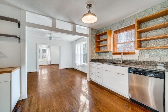 2615 W Brooklyn Ave, Dallas, TX 75211 - kitchen with open shelves, stainless steel dishwasher, a sink, decorative backsplash, and dark wood-type flooring