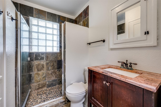 2615 W Brooklyn Ave, Dallas, TX 75211 - bathroom featuring toilet, a shower stall, and vanity
