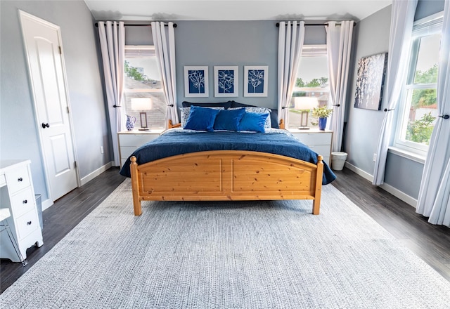 bedroom featuring dark wood-style flooring and baseboards