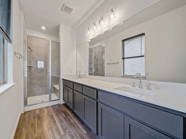 240 Harper St, Irving, TX 75063 - full bathroom with a shower stall, double vanity, wood finished floors, baseboards, and recessed lighting