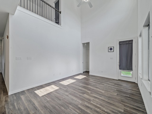 240 Harper St, Irving, TX 75063 - unfurnished living room with a towering ceiling, a ceiling fan, dark wood finished floors, and baseboards