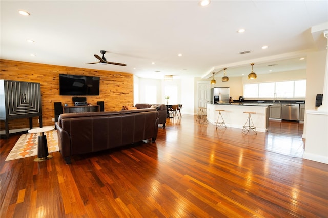 6318 White Oaks Ln, Frisco, TX 75035 - living room with dark wood-style flooring, ceiling fan, wood walls, and recessed lighting