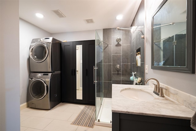 6318 White Oaks Ln, Frisco, TX 75035 - bathroom with estacked washer and dryer, a stall shower, tile patterned flooring, vanity, and recessed lighting
