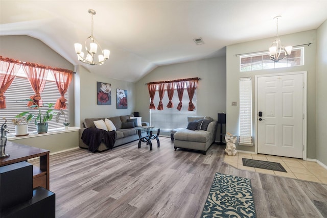 809 Fox Run Trl, Saginaw, TX 76179 - foyer entrance featuring a chandelier, vaulted ceiling, plenty of natural light, wood finished floors, and baseboards