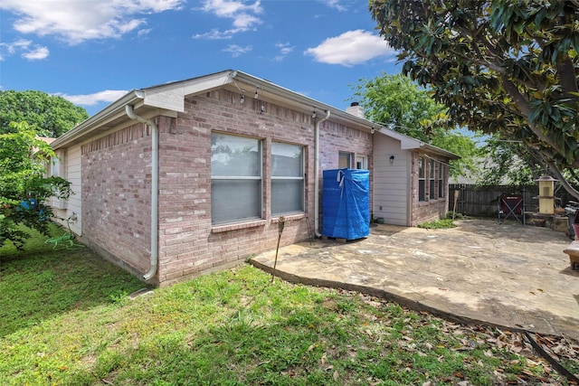 809 Fox Run Trl, Saginaw, TX 76179 - back of house with a patio area, brick siding, and a chimney