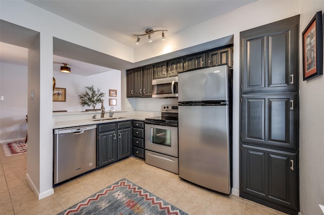 7640 W Greenway Blvd Unit 8L, Dallas, TX 75209 - kitchen featuring stainless steel appliances, light tile patterned floors, light countertops, and a sink