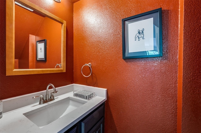 7640 W Greenway Blvd Unit 8L, Dallas, TX 75209 - bathroom featuring a textured wall and vanity