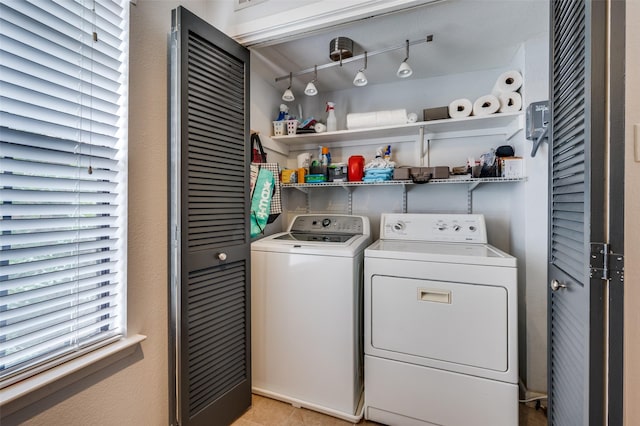 7640 W Greenway Blvd Unit 8L, Dallas, TX 75209 - washroom with washer and clothes dryer and light tile patterned floors