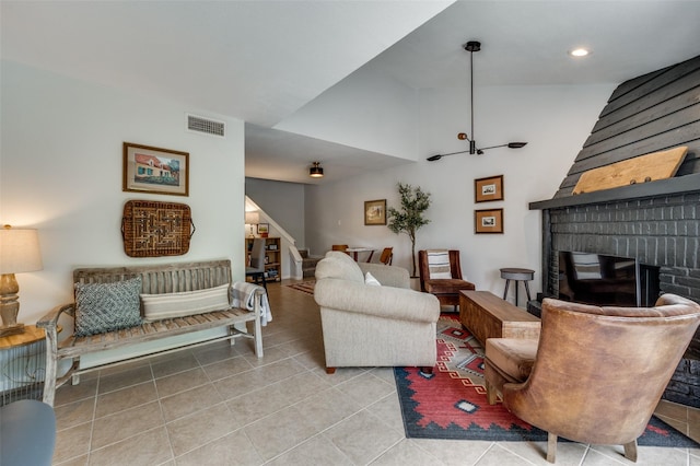 7640 W Greenway Blvd Unit 8L, Dallas, TX 75209 - living room with stairs, a brick fireplace, tile patterned floors, and recessed lighting