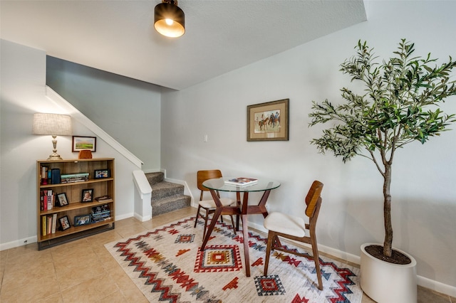 7640 W Greenway Blvd Unit 8L, Dallas, TX 75209 - living area featuring stairway, baseboards, and tile patterned flooring