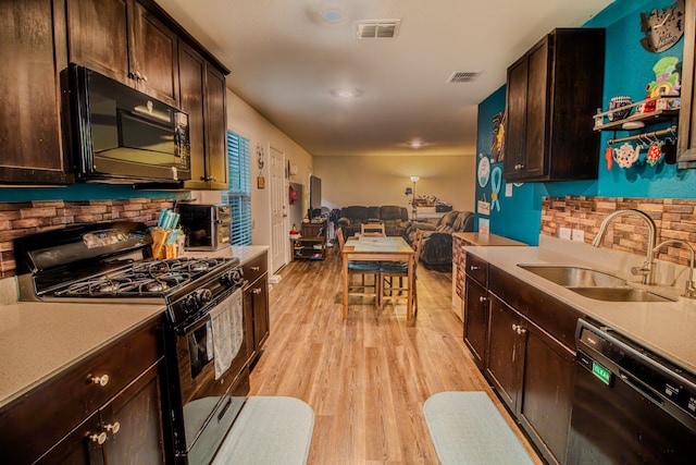 1141 Avalon Dr, Crandall, TX 75114 - kitchen with black appliances, a sink, open floor plan, decorative backsplash, and recessed lighting