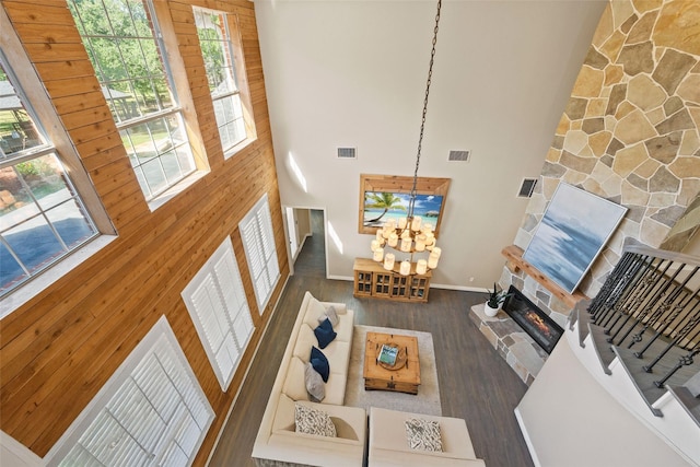 710 Eagles Landing Blvd, Oak Point, TX 75068 - living area with a high ceiling, a chandelier, a fireplace, wood finished floors, and healthy amount of natural light