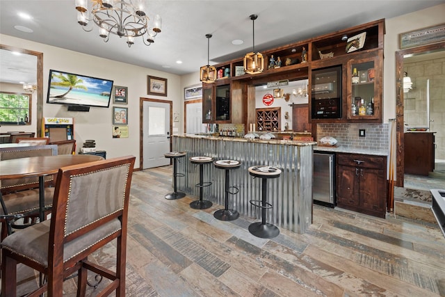 710 Eagles Landing Blvd, Oak Point, TX 75068 - indoor wet bar with recessed lighting, decorative backsplash, wine cooler, light wood-style floors, and a chandelier