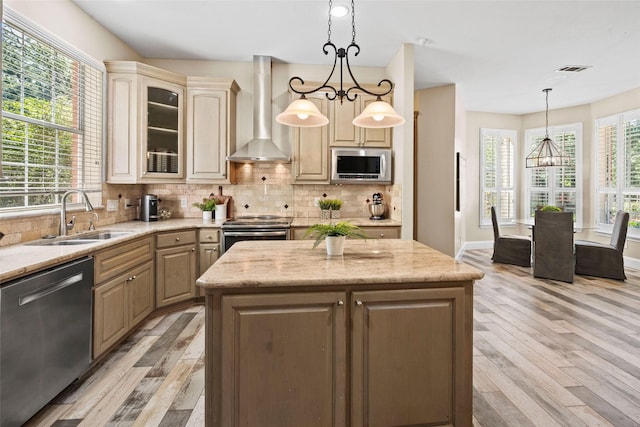 710 Eagles Landing Blvd, Oak Point, TX 75068 - kitchen with a sink, wall chimney exhaust hood, appliances with stainless steel finishes, a chandelier, and light wood-style flooring