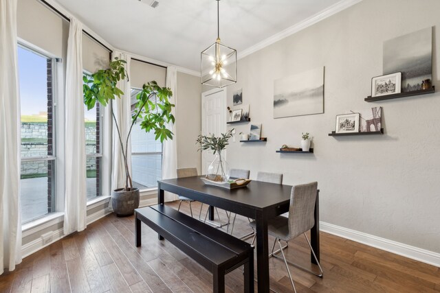 121 Lafayette Lndg, Heath, TX 75032 - dining space featuring plenty of natural light, wood finished floors, baseboards, crown molding, and a chandelier