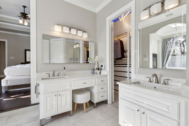 121 Lafayette Lndg, Heath, TX 75032 - ensuite bathroom with crown molding, two vanities, a ceiling fan, and a walk in closet