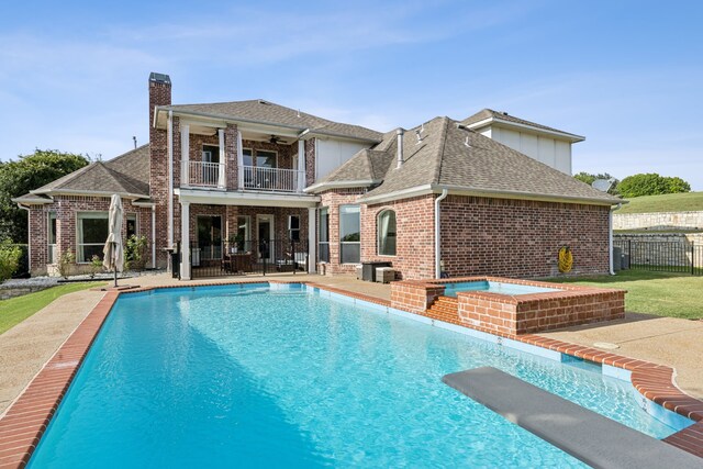 121 Lafayette Lndg, Heath, TX 75032 - rear view of house with a balcony, a ceiling fan, a chimney, fence, and brick siding