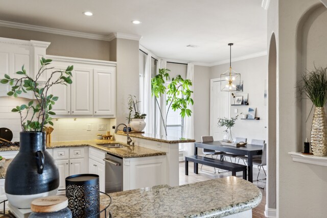 121 Lafayette Lndg, Heath, TX 75032 - kitchen featuring a sink, white cabinets, light stone counters, dishwasher, and a peninsula