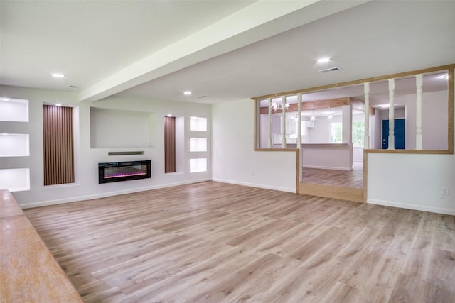 4840 Overton Ave, Fort Worth, TX 76133 - unfurnished living room with baseboards, light wood finished floors, a glass covered fireplace, and recessed lighting