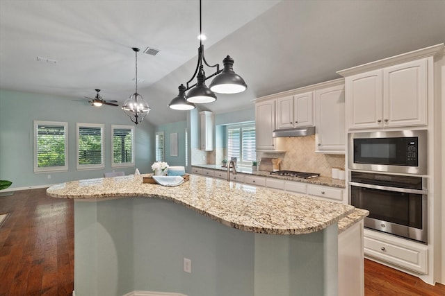 413 Sloan Creek Pkwy, Fairview, TX 75069 - kitchen featuring appliances with stainless steel finishes, lofted ceiling, decorative backsplash, white cabinetry, and a ceiling fan