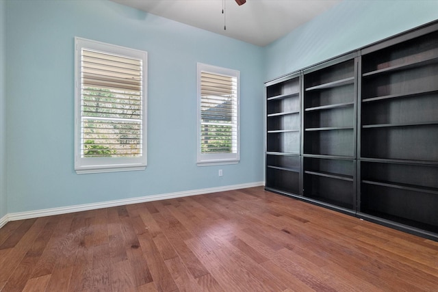 413 Sloan Creek Pkwy, Fairview, TX 75069 - unfurnished room with wood finished floors, a ceiling fan, and baseboards
