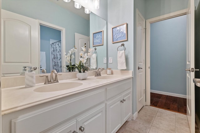 413 Sloan Creek Pkwy, Fairview, TX 75069 - full bath featuring tile patterned flooring, double vanity, and baseboards