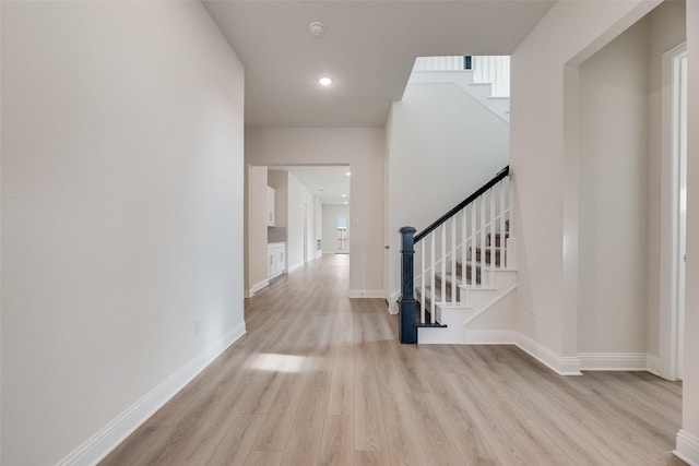 7104 Manhattan Dr, Rowlett, TX 75088 - hall with wood finished floors, stairs, baseboards, and recessed lighting