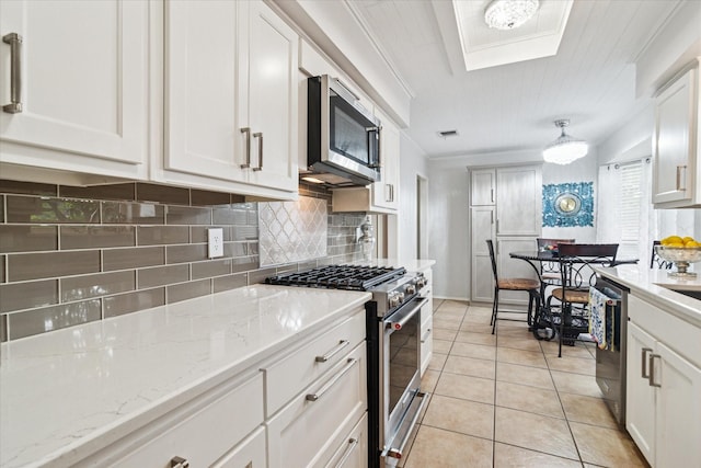 4021 Tracey Trl, Rowlett, TX 75088 - kitchen with appliances with stainless steel finishes, backsplash, white cabinetry, light tile patterned floors, and light stone countertops