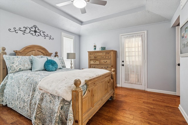 4021 Tracey Trl, Rowlett, TX 75088 - bedroom featuring wood finished floors, a tray ceiling, baseboards, and access to outside