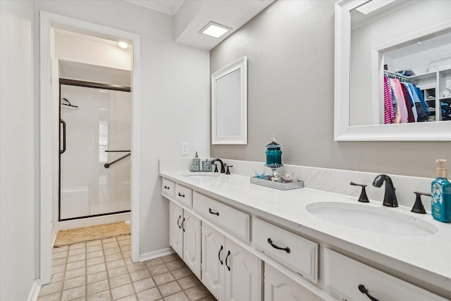 4021 Tracey Trl, Rowlett, TX 75088 - bathroom featuring a stall shower, double vanity, a spacious closet, tile patterned flooring, and baseboards