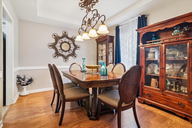 4021 Tracey Trl, Rowlett, TX 75088 - dining space featuring light wood-type flooring, a raised ceiling, and baseboards