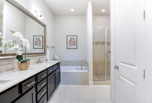 5005 Meridian Ln Unit 3102, Addison, TX 75001 - bathroom with double vanity, a garden tub, a stall shower, tile patterned floors, and recessed lighting