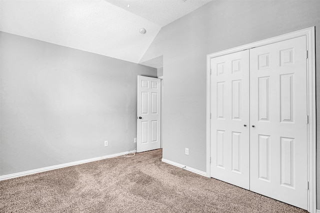3501 Thorp Springs Dr, Plano, TX 75025 - unfurnished bedroom with carpet flooring, vaulted ceiling, a closet, a textured ceiling, and baseboards