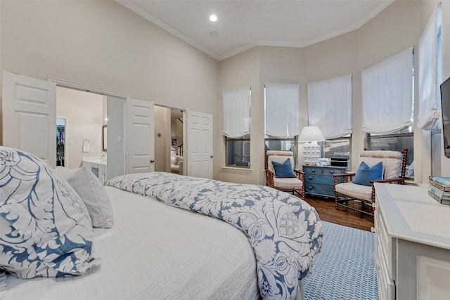 2307 Grizzly Run Ln, Euless, TX 76039 - bedroom with crown molding, dark wood-style flooring, a towering ceiling, and connected bathroom