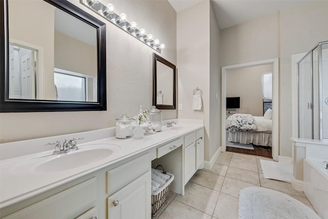 2307 Grizzly Run Ln, Euless, TX 76039 - ensuite bathroom featuring tile patterned floors, double vanity, a bath, and an enclosed shower