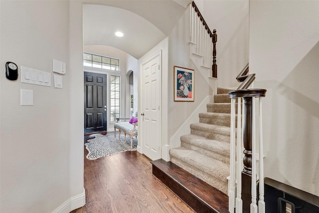 2307 Grizzly Run Ln, Euless, TX 76039 - foyer featuring arched walkways, wood finished floors, baseboards, stairs, and vaulted ceiling