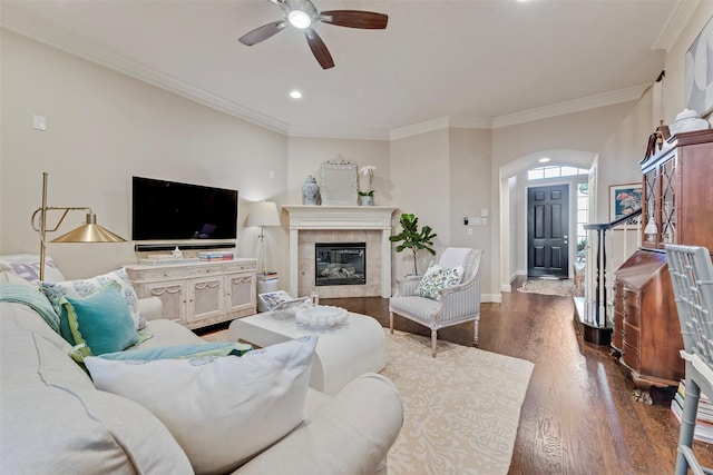 2307 Grizzly Run Ln, Euless, TX 76039 - living area with arched walkways, ceiling fan, dark wood-style floors, crown molding, and recessed lighting