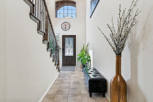 9812 Beaver Dam Ln, Mckinney, TX 75071 - entrance foyer featuring baseboards, stairway, a high ceiling, and light tile patterned flooring