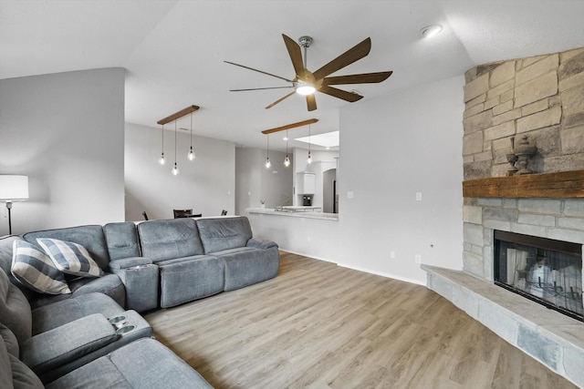 713 Bridle Trl, Saginaw, TX 76179 - living area featuring a ceiling fan, wood finished floors, and a stone fireplace
