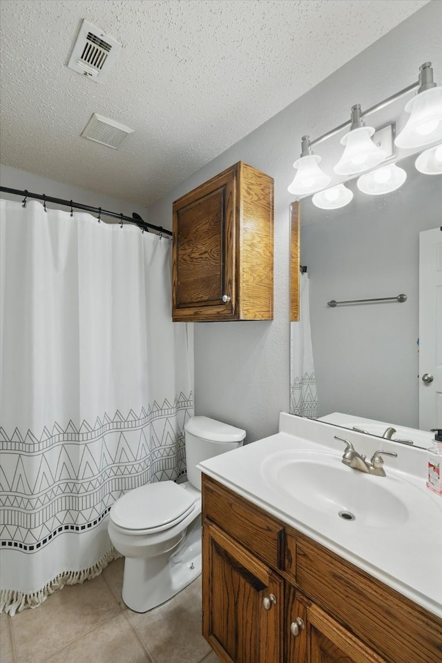 713 Bridle Trl, Saginaw, TX 76179 - bathroom with vanity, a textured ceiling, toilet, and tile patterned floors