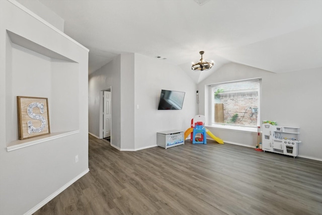 713 Bridle Trl, Saginaw, TX 76179 - unfurnished living room with wood finished floors, a chandelier, baseboards, and vaulted ceiling