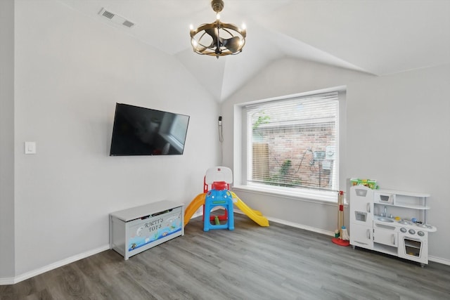 713 Bridle Trl, Saginaw, TX 76179 - recreation room featuring wood finished floors, a chandelier, baseboards, and vaulted ceiling
