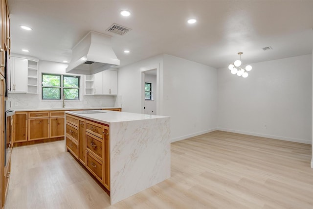 2317 Vega St, Grand Prairie, TX 75050 - kitchen with open shelves, light wood-type flooring, custom exhaust hood, a center island, and recessed lighting