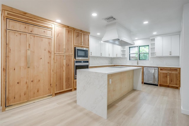 2317 Vega St, Grand Prairie, TX 75050 - kitchen featuring appliances with stainless steel finishes, open shelves, premium range hood, light wood-style flooring, and a kitchen island