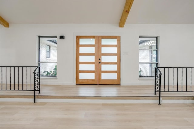 2317 Vega St, Grand Prairie, TX 75050 - entrance foyer featuring wood finished floors, beam ceiling, and healthy amount of natural light