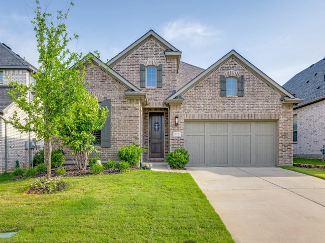 217 Fulton St, Oak Point, TX 75068 - view of front of home with brick siding, driveway, a front yard, and a garage