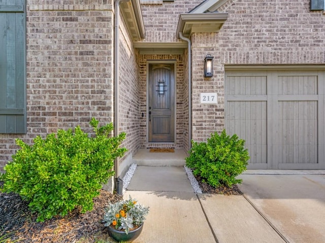 217 Fulton St, Oak Point, TX 75068 - property entrance featuring a garage and brick siding