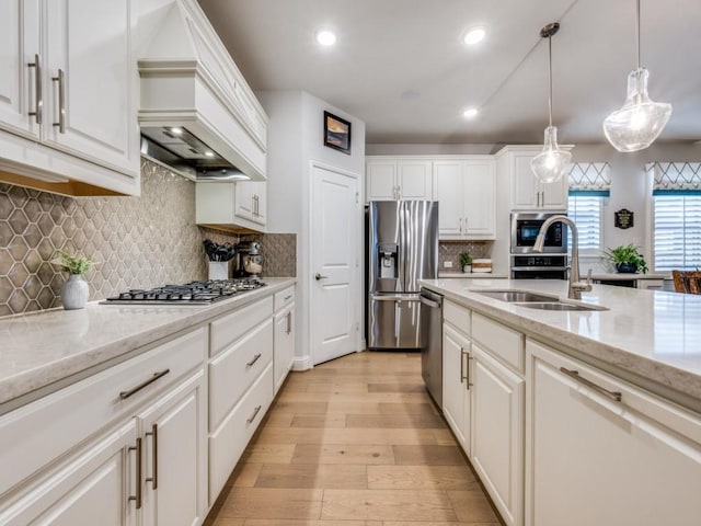 217 Fulton St, Oak Point, TX 75068 - kitchen with stainless steel appliances, a sink, custom range hood, light wood-style flooring, and white cabinets