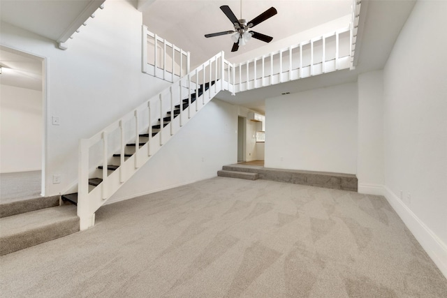 129 Western Ave, Saginaw, TX 76179 - unfurnished living room featuring carpet flooring, stairs, ceiling fan, and a high ceiling